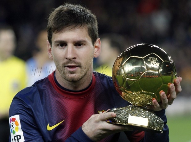 Barcelona's player Messi shows his Ballon d'Or trophy before their Spanish King's Cup soccer match against Malaga in Barcelona