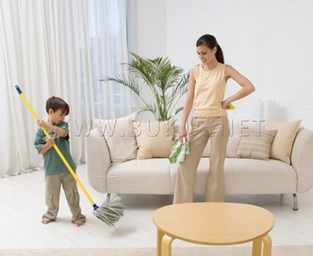 Mother and son cleaning house together